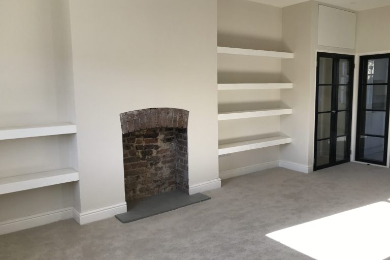 empty fireplace with wall racks 2